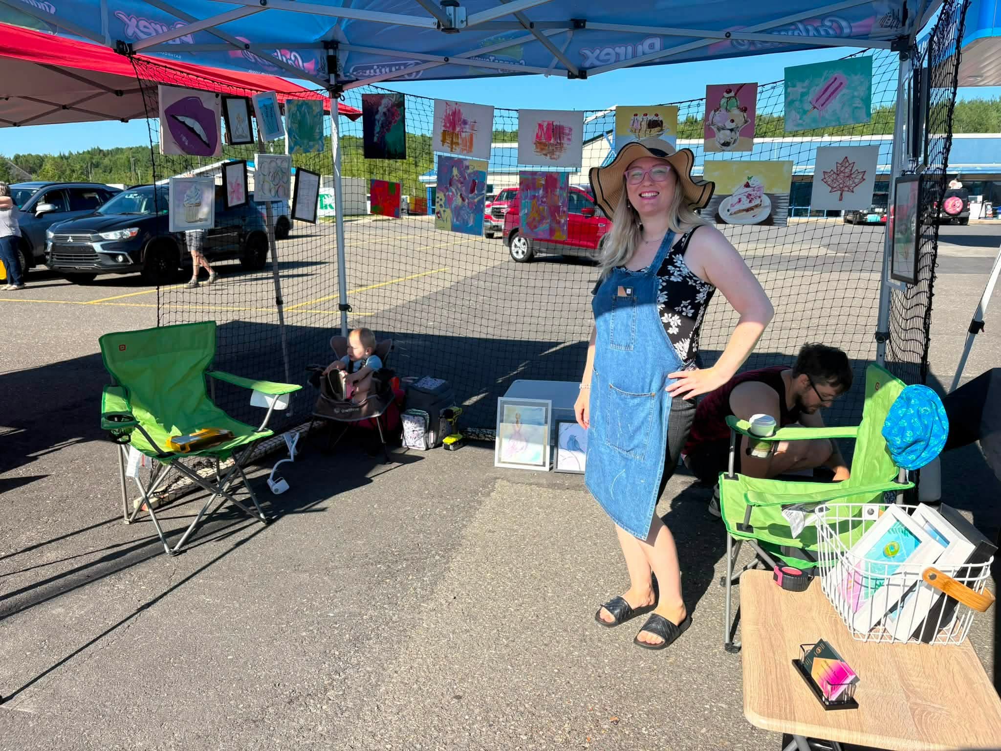 Jacqueline displaying her paintings at an outdoor art market